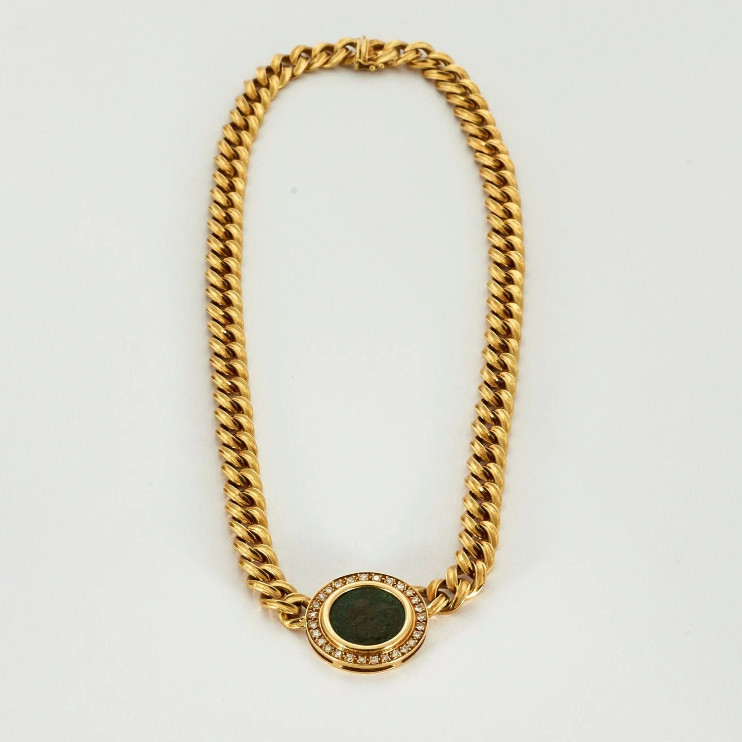 Yellow gold diamond necklace centered on a bronze piece